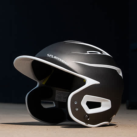 A batting helmet on the ground in the dugout