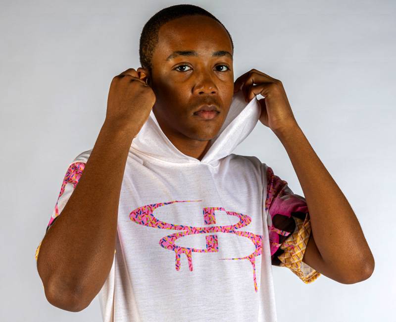 Boy in a pink and white ice cream graphic short sleeve hoodie