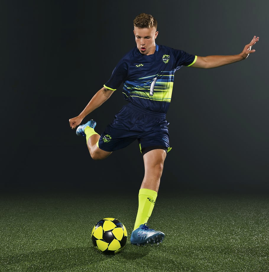 man playing soccer in custom soccer uniforms