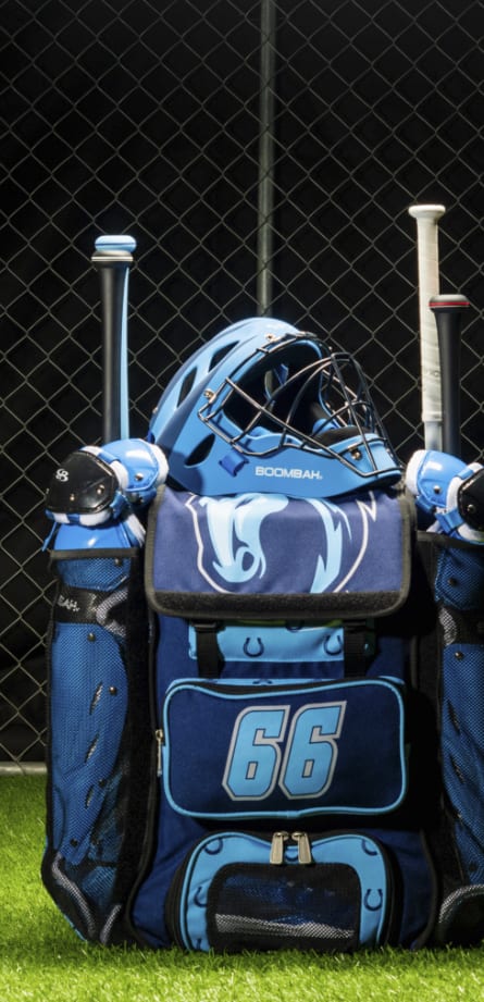 A blue bat bag filled with baseball equipment