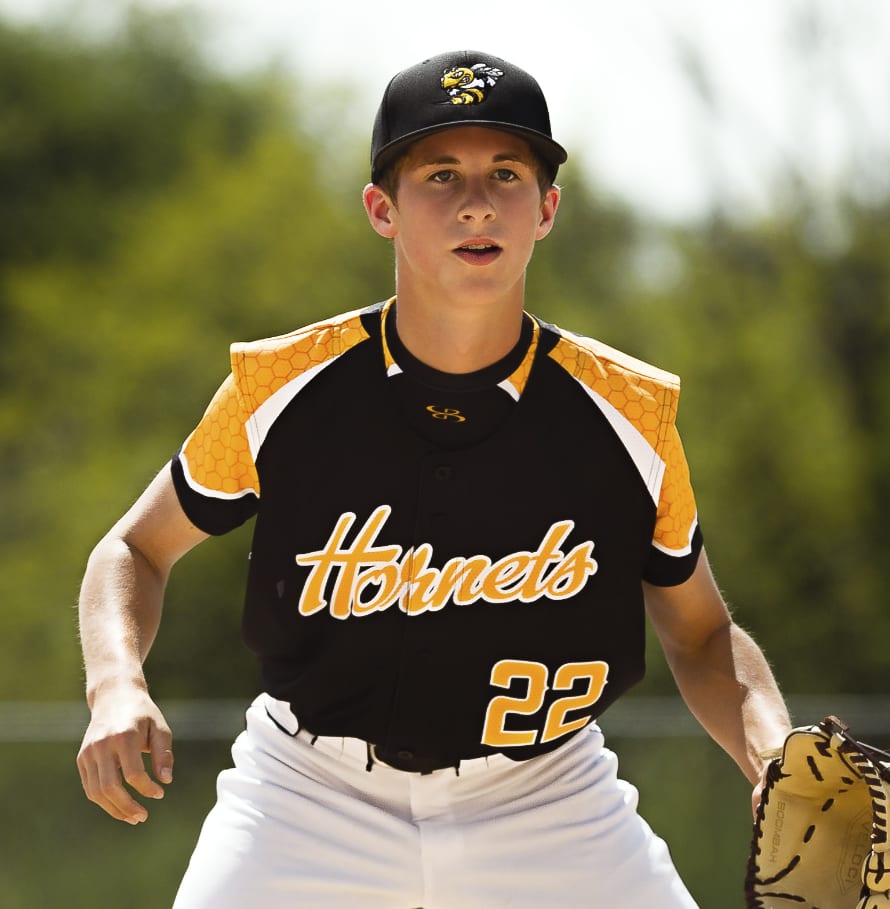 A baseball player in a black, yellow and white jersey